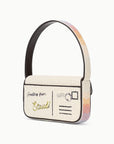 Handbag designed like a vintage postcard with rainbow handle on a white background