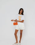 model wearing amalfi spritz short sleeve tee with white shorts on a white background