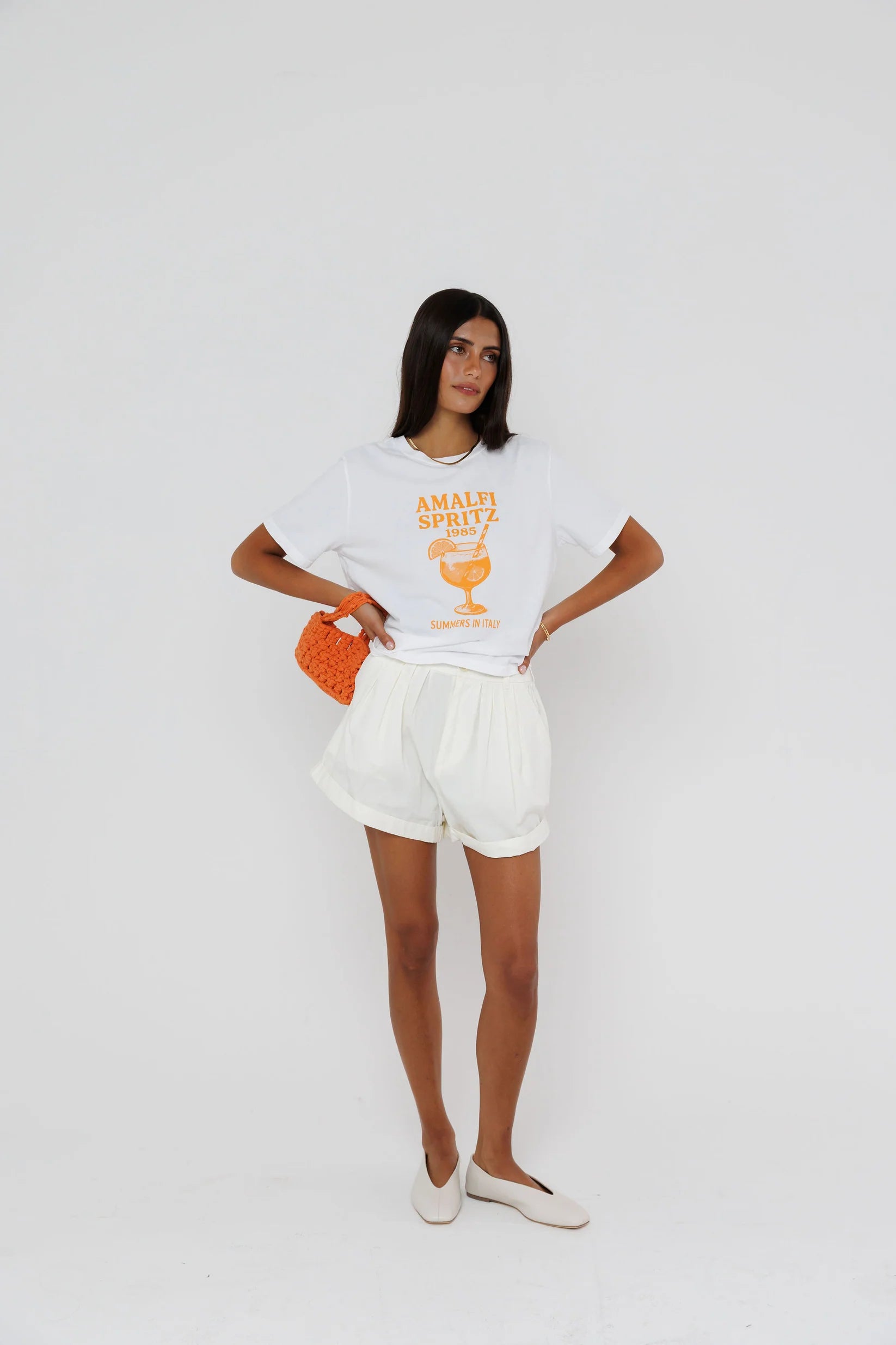 model wearing amalfi spritz short sleeve tee with white shorts on a white background
