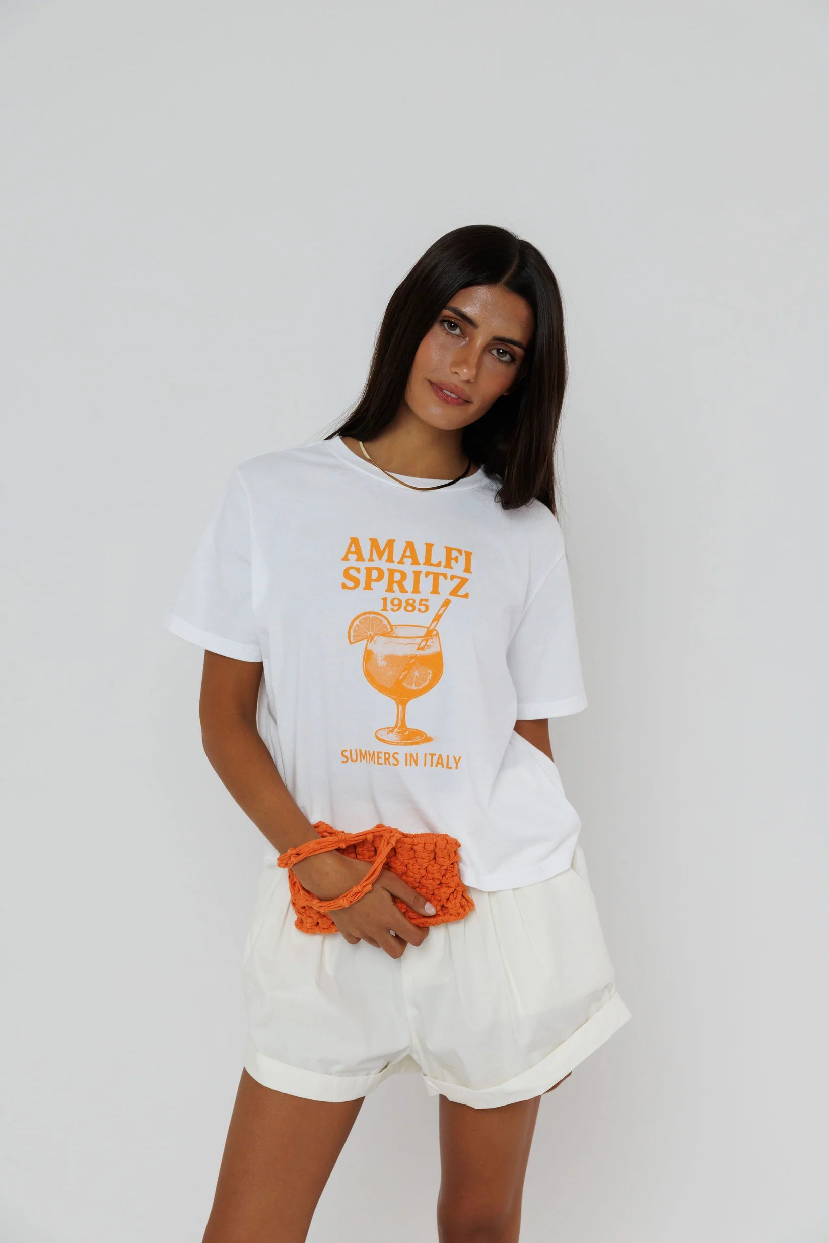model wearing amalfi spritz short sleeve tee with white shorts on a white background