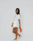 model wearing amalfi spritz short sleeve tee with white shorts on a white background