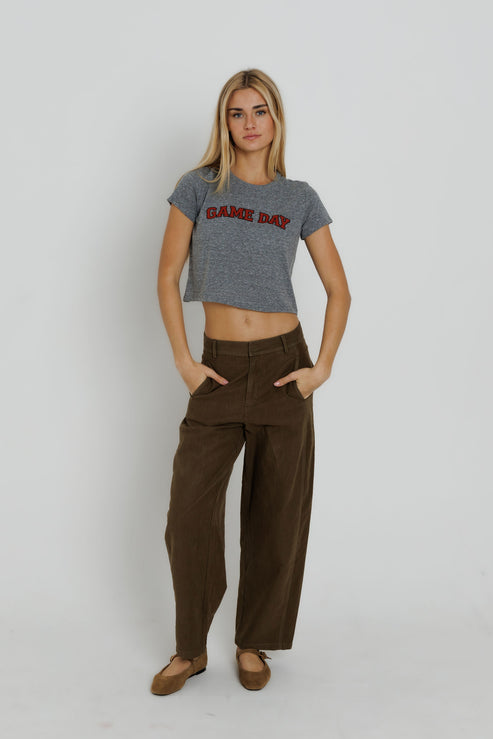 Red Game Day Tiny Tee full body front view on model with both hands in her pockets