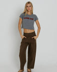 Red Game Day Tiny Tee full body front view on model with both hands in her pockets