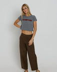 Red Game Day Tiny Tee full body front view on model with one hand on hip