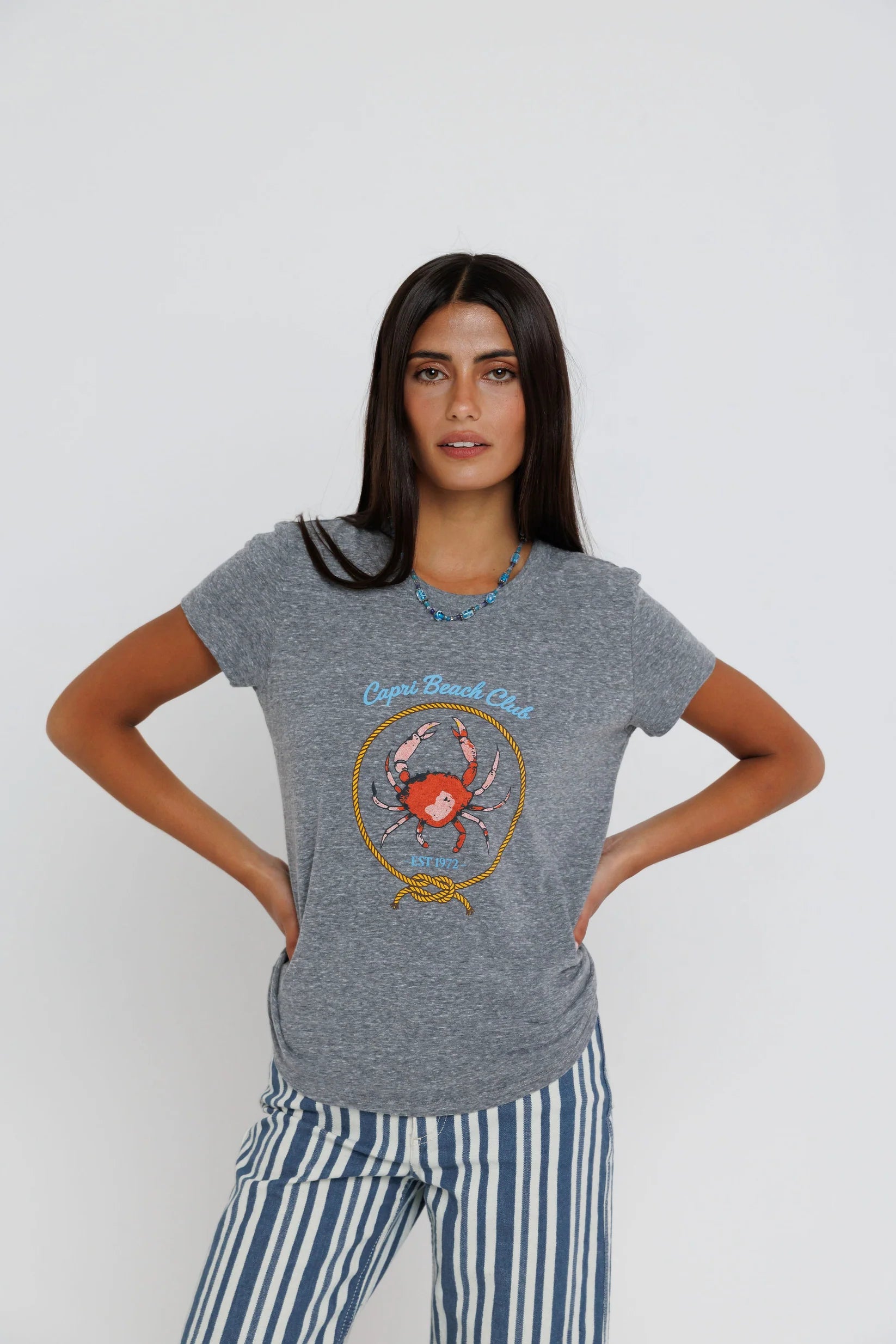 Capri Beach Club Femme Crew on a model with stripe pants on a white background