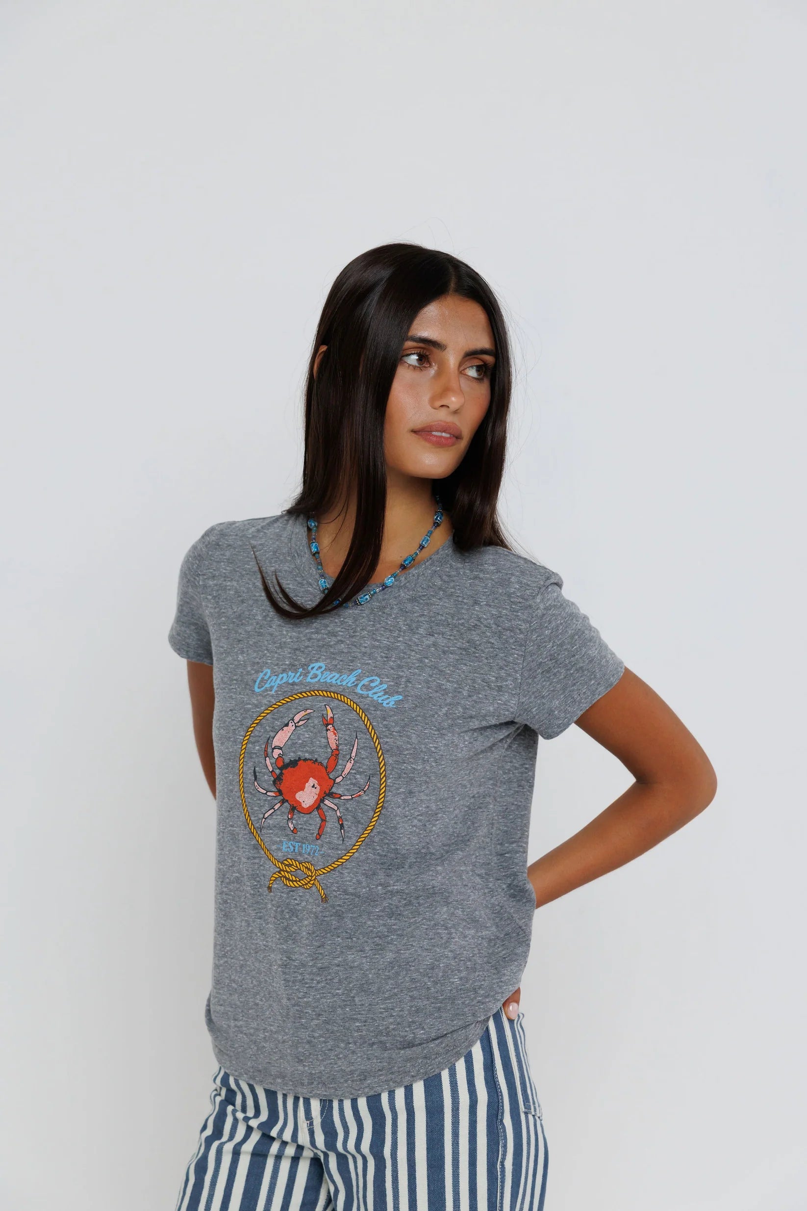 Capri Beach Club Femme Crew on a model with stripe pants on a white background