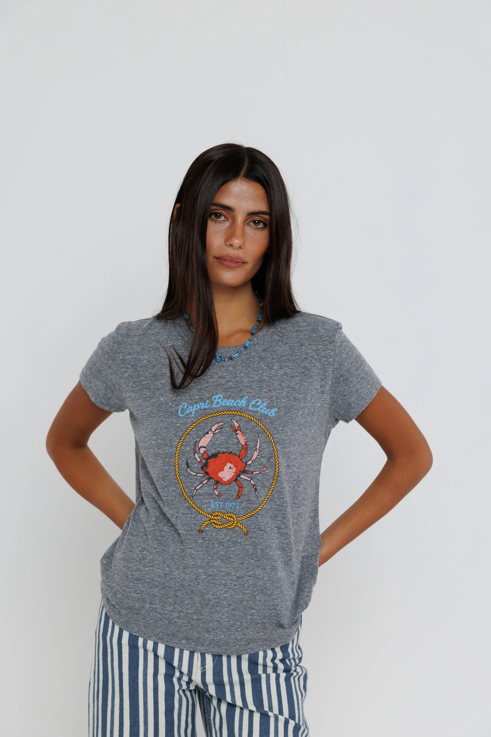 Capri Beach Club Femme Crew on a model with stripe pants on a white background