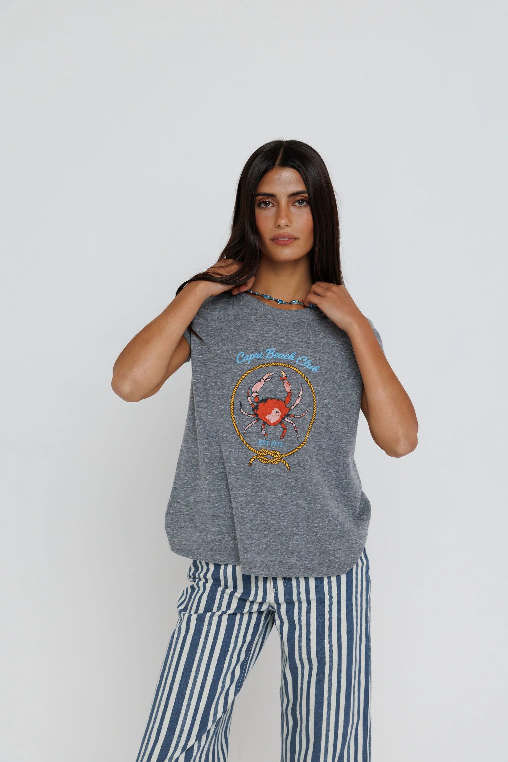 Capri Beach Club Femme Crew on a model with stripe pants on a white background