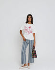 Palm Beach Hotel Tee full body front view on model with arm on waist