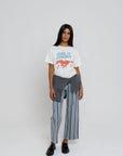 model wearing cool it cowboy tee with stripe pants on a white background