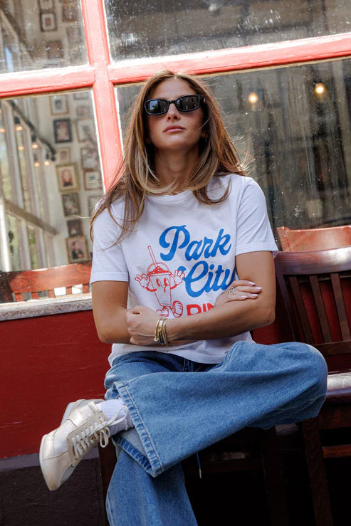 Park City Dinner Everyday Tee front, model's arms crossed