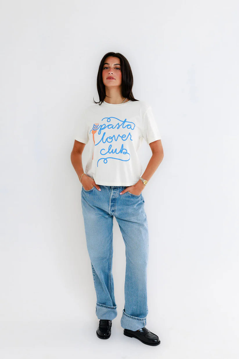 Person wearing a white t-shirt with 'pasta lover club' text and blue jeans on a white background, full body front