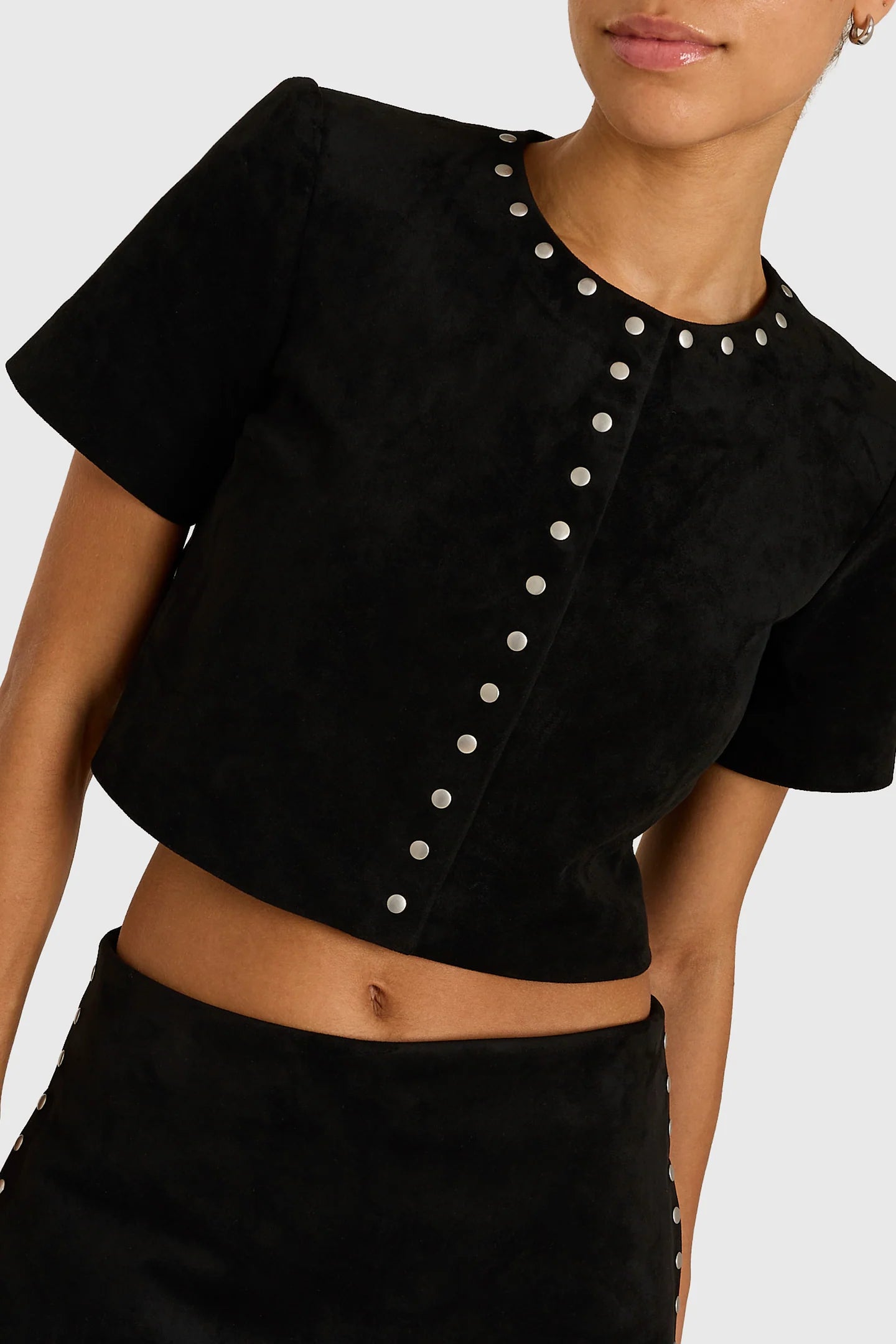 Model wearing studded black shirt