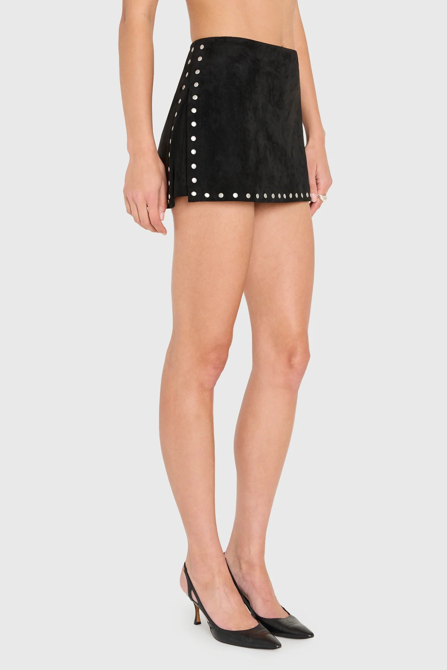 Model wearing black skirt with studs on White background