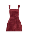 A sleeveless wine red velvet mini dress with shoulder straps, a matching belt with a square buckle, and front patch pockets, shown against a plain white background.