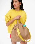 Sac Tout Backpack held in front of model