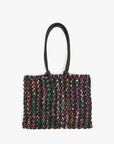 Multicolored textured handbag with a black handle on a white background