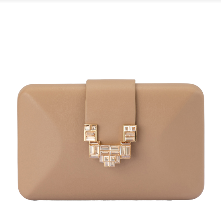 Beige clutch bag with decorative clasp on a white background