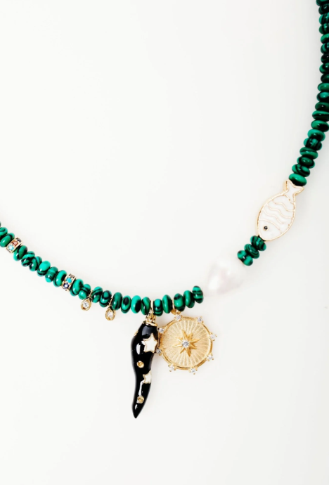 Necklace with green beads and decorative elements on a white background