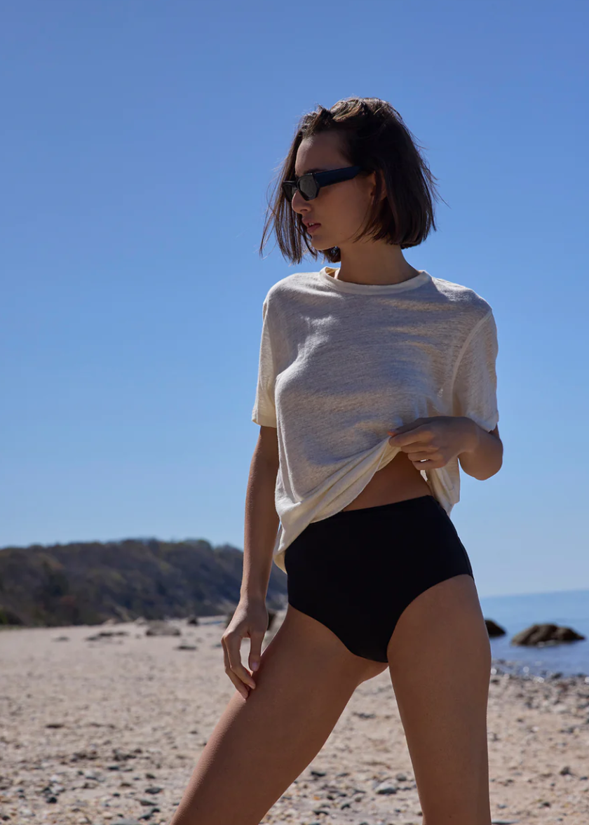 The Linen Perfect Tee In Cream with black swim bottoms