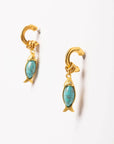 Gold earrings with turquoise stones on a white background