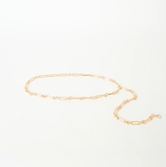 Gold chain belt on a light gray background