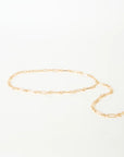 Gold chain belt on a light gray background