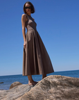 The RSVP Dress, model standing on rock
