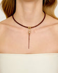 Necklace with leather chain on a plain background