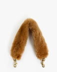 A camel brown faux fur shoulder strap with gold-tone metal swivel clasp hardware, shown against a plain white background.