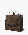 Leopard print handbag with black handles and trim on a white background
