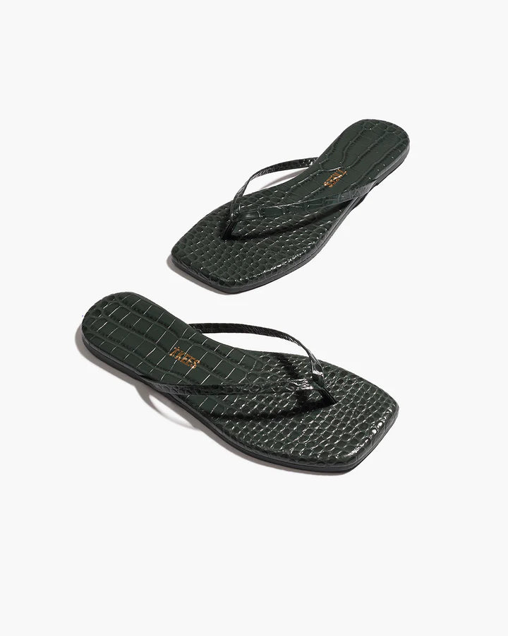 Pair of black flip-flops on a white background