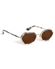 Hexagonal sunglasses with brown tinted lenses, a gold metal frame, and tortoiseshell-patterned temples on a white background.
