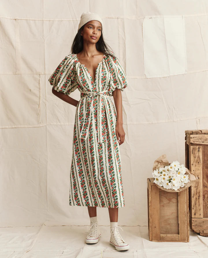 Woman wearing a floral dress with a plain background