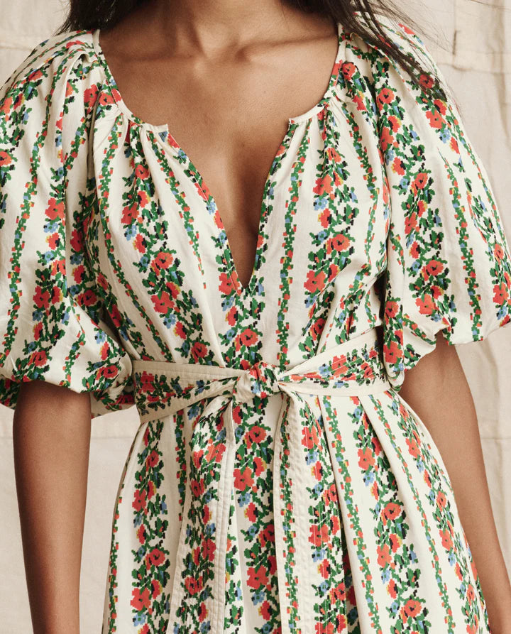 Floral dress with a tie waist on a neutral background