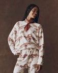 Woman wearing a patterned outfit with a brown background
