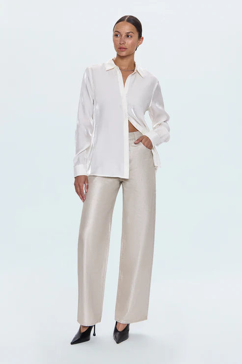 Woman wearing a white blouse and beige pants on a white background