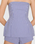 model wearing a strapless top and short set in blue and ivory stripes