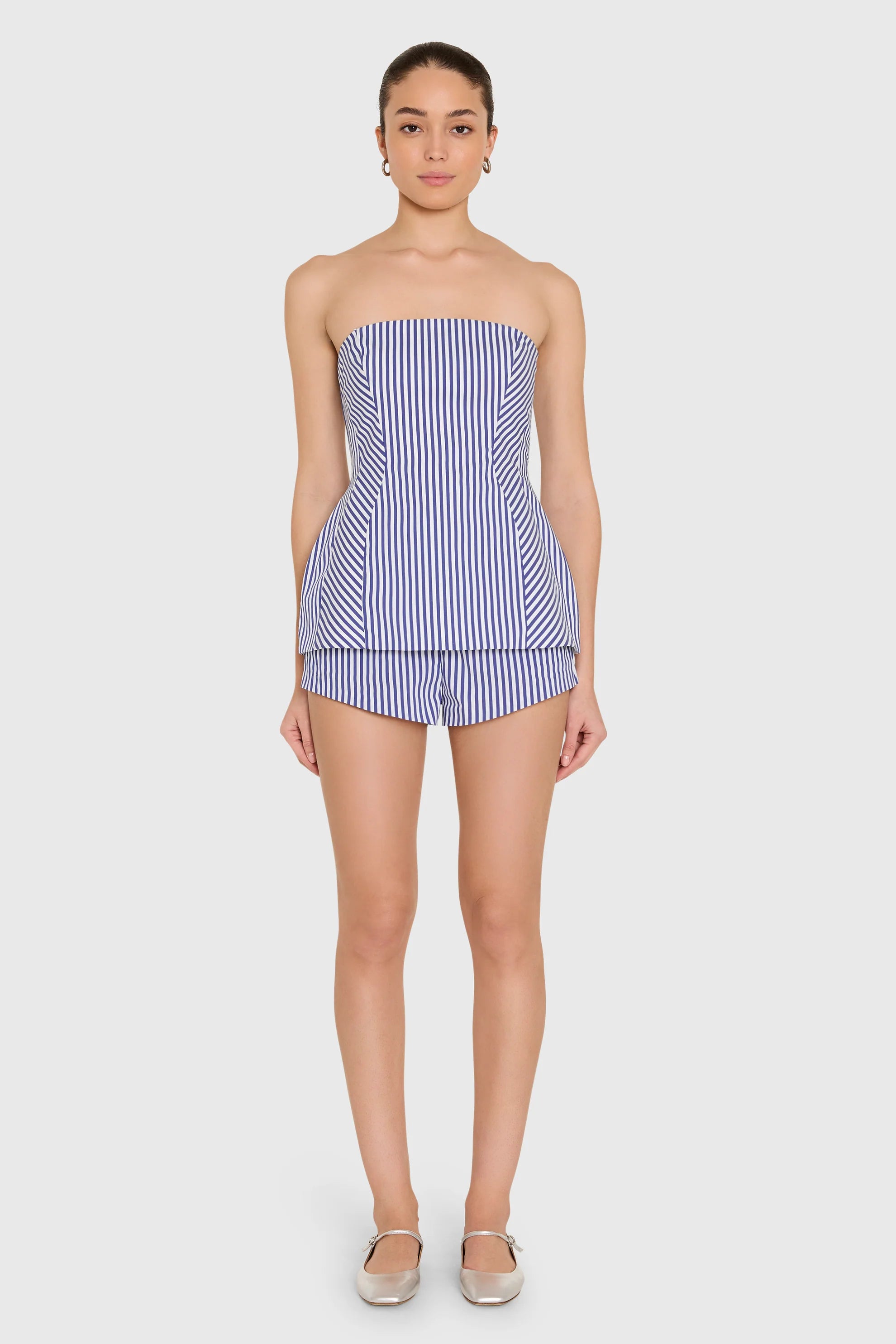 model wearing a strapless top and short set in blue and ivory stripes