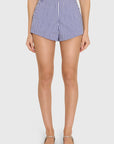 model wearing blue and ivory striped shorts on a white background