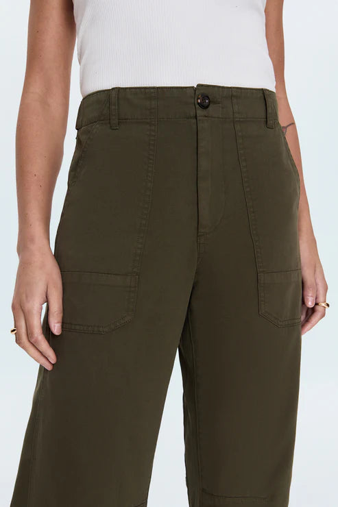 Person wearing olive green cargo pants on a white background