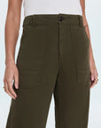 Person wearing olive green cargo pants on a white background