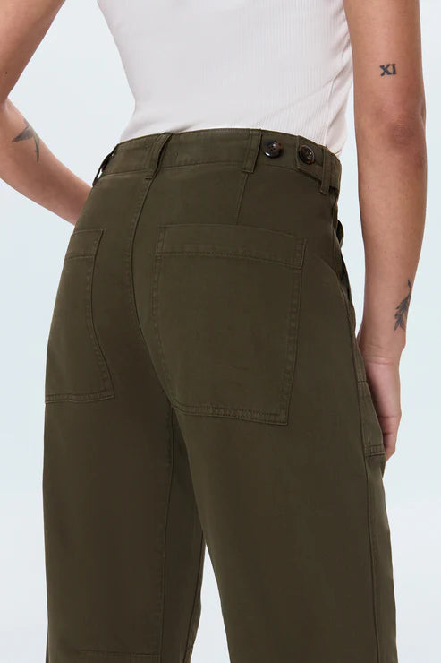 Person wearing olive green pants on a white background