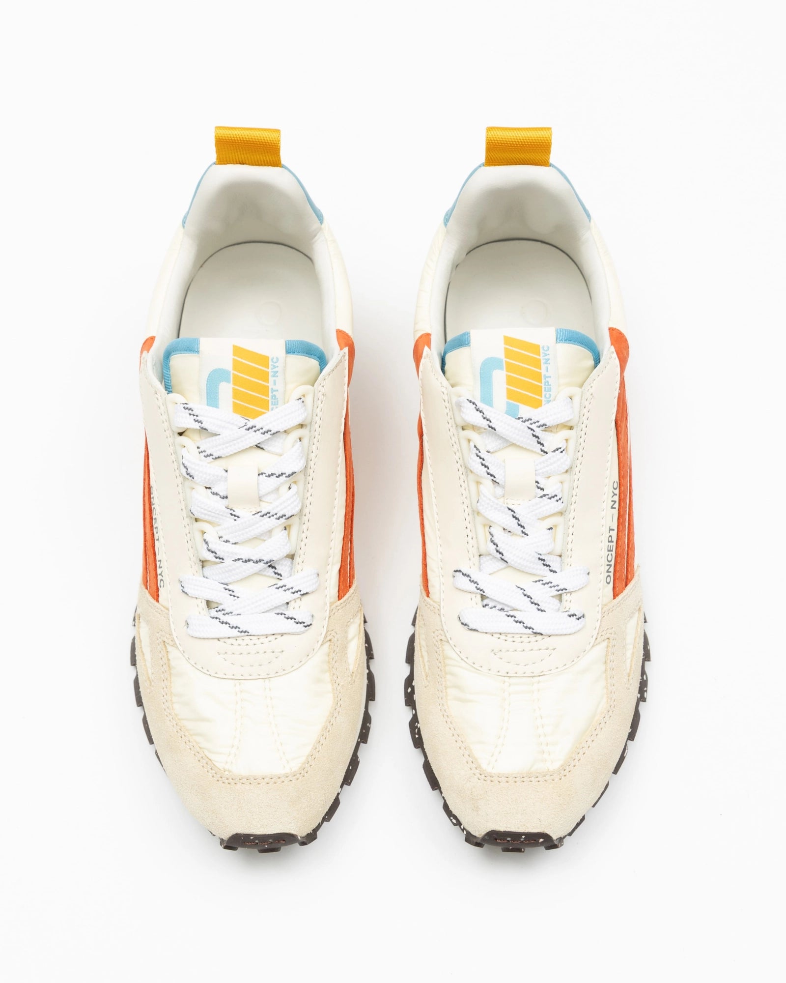 Pair of white sneakers with orange, blue and yellow accents on a white background