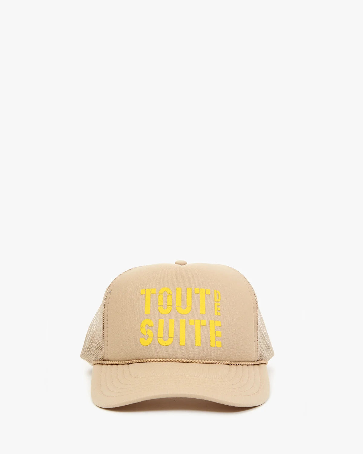 A beige trucker-style cap with yellow embroidered text reading 'TOUT DE SUITE' on the front, shown against a plain white background.