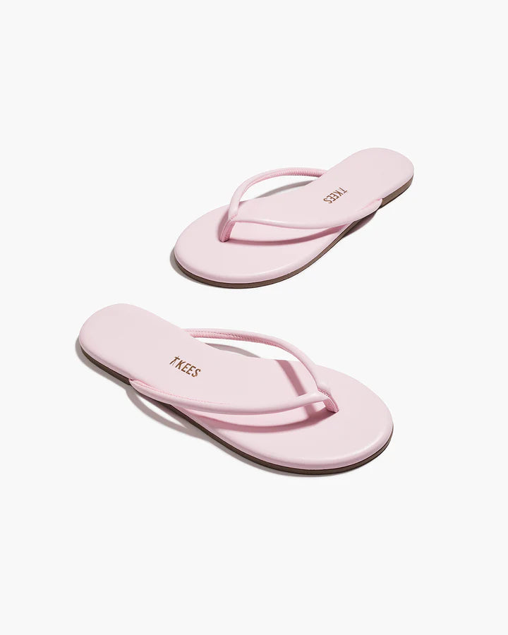 Pair of pink flip-flops on a white background