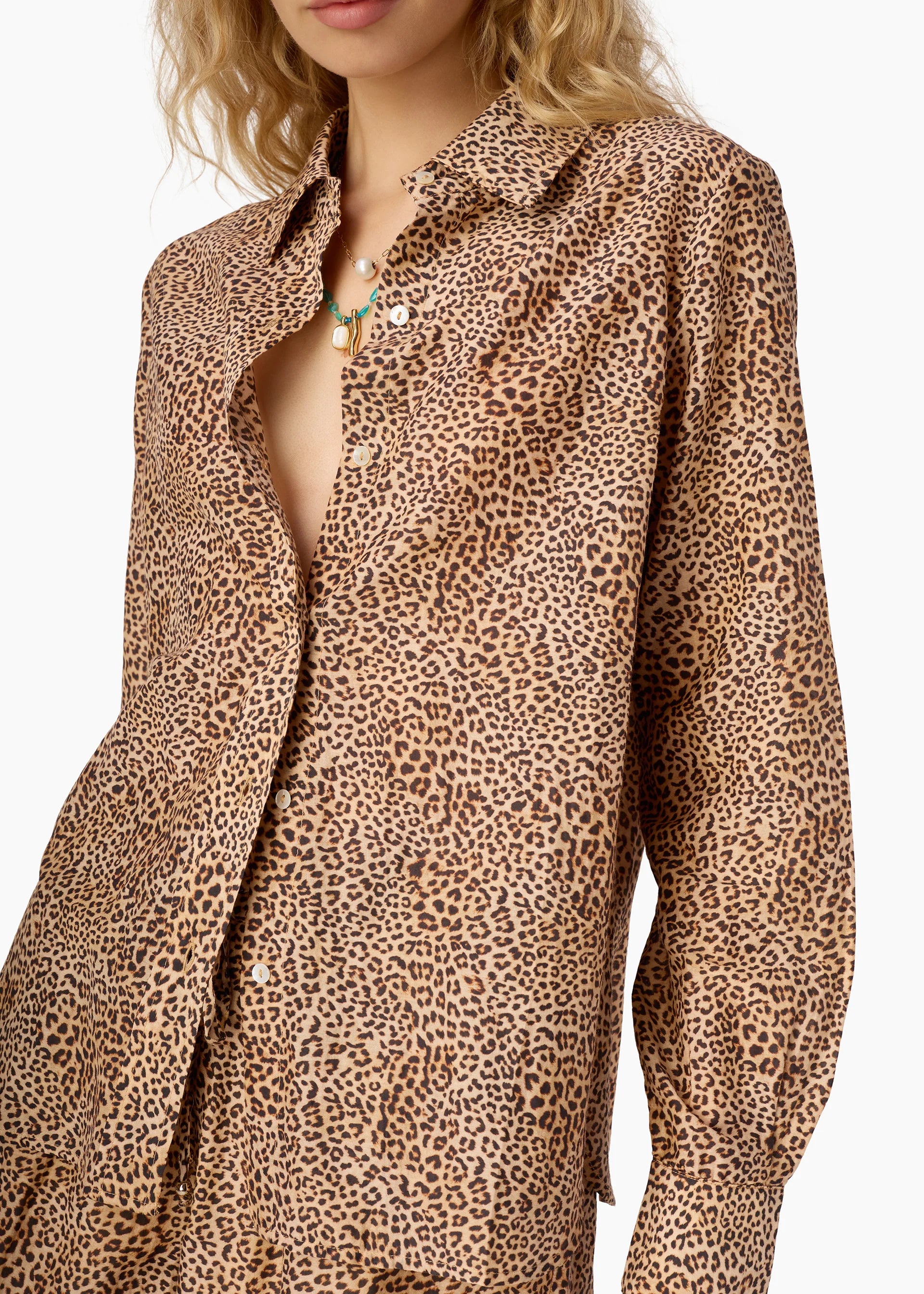 Leopard print shirt worn by a person on a white background