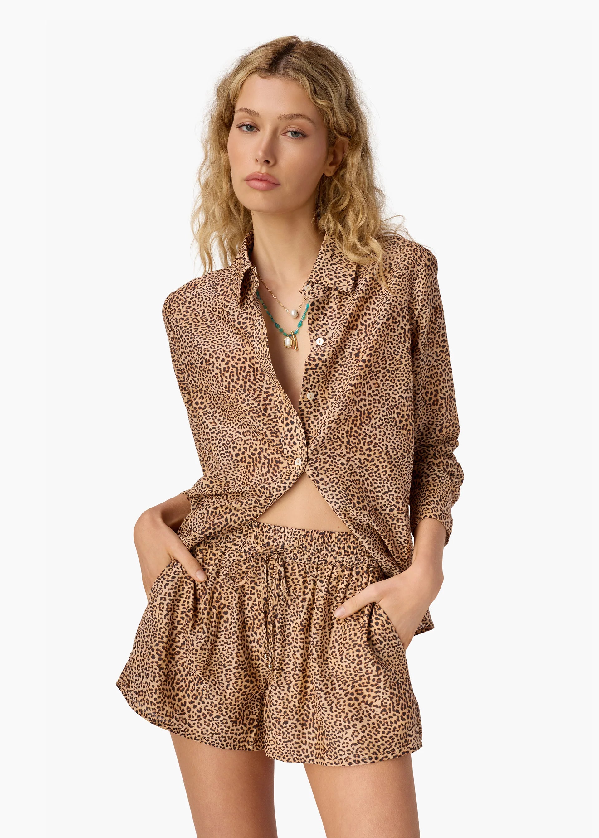 Woman wearing a leopard print outfit on a white background