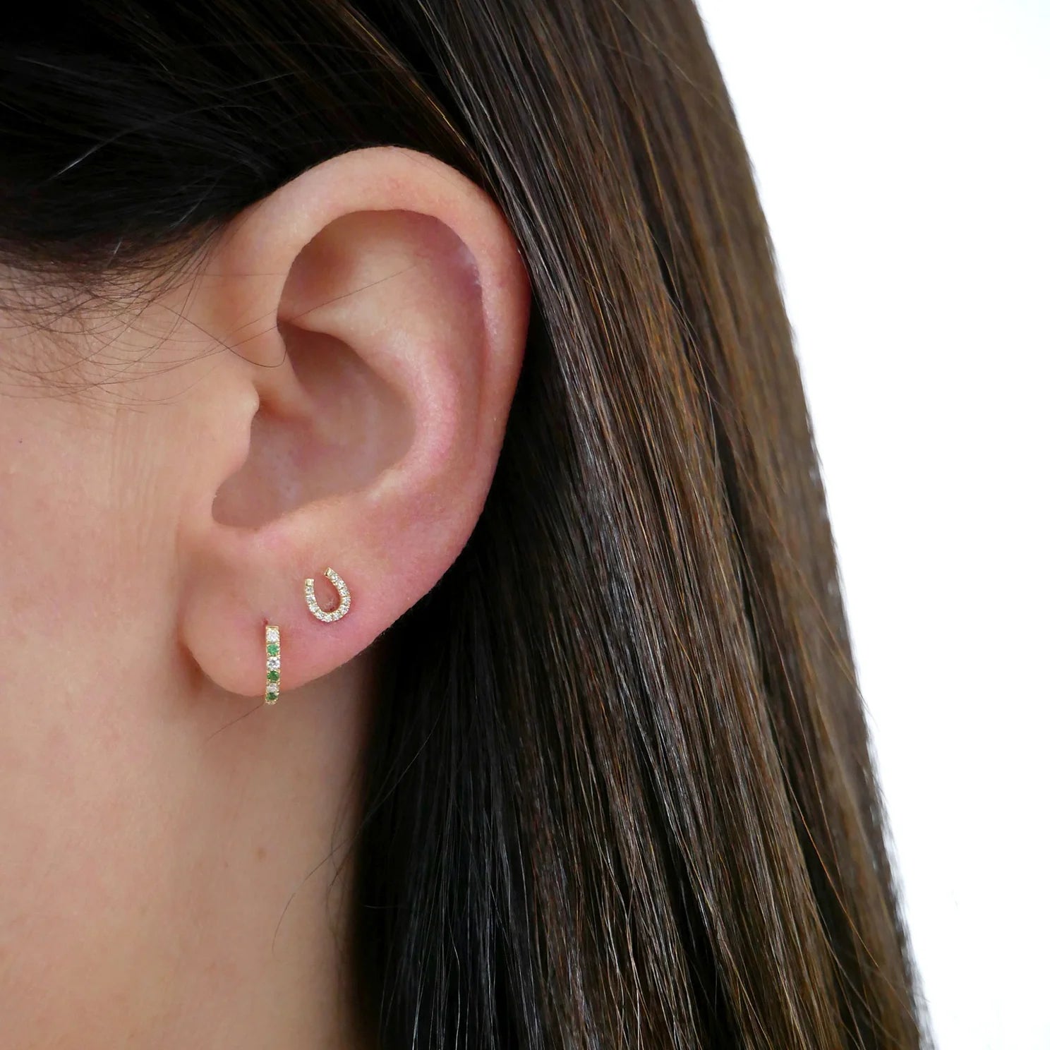 Single Diamond Mini Horseshoe Stud Earring on ear in second hole