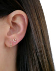 Single Diamond Mini Horseshoe Stud Earring on ear in second hole